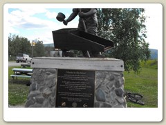 Monument to miners in the park by the river