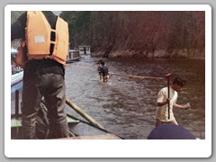 Local residents trying to free shallow draft boats that are stuck on the bottom